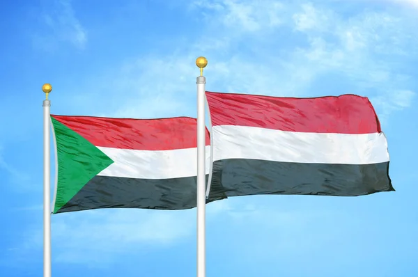 Sudão Iêmen Duas Bandeiras Postes Bandeira Fundo Azul Céu Nublado — Fotografia de Stock