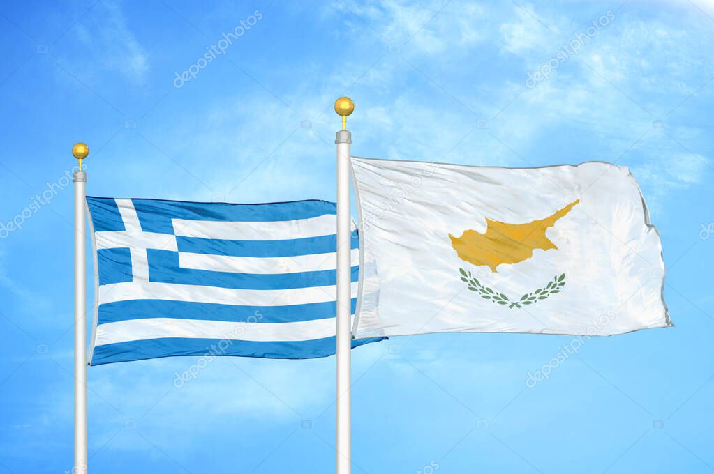 Greece and Cyprus two flags on flagpoles and blue cloudy sky background
