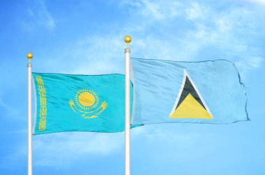 Kazakistan ve Aziz Lucia bayrak direkleri ve mavi bulutlu arka planda iki bayrak