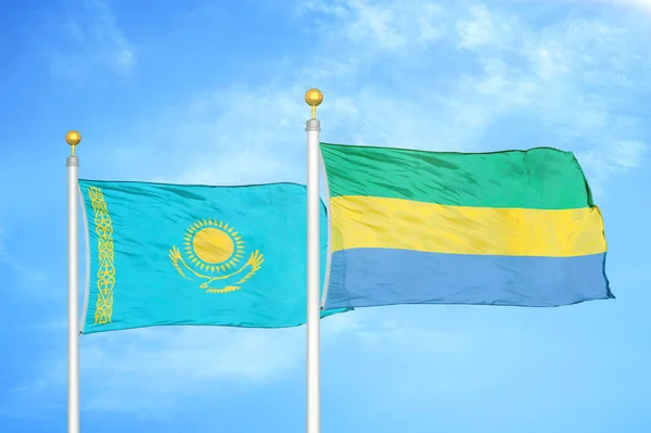 Kazakstan Och Gabon Två Flaggor Flaggstänger Och Blå Molnig Himmel — Stockfoto