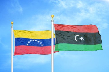 Venezuela ve Libya bayrak direkleri ve mavi bulutlu arka planda iki bayrak