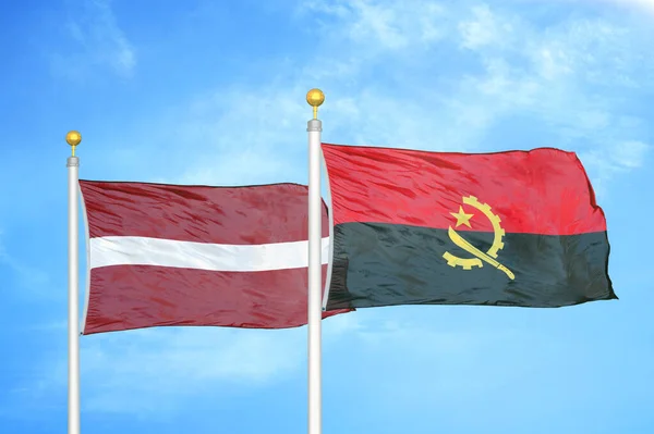 Letonya Angola Bayrak Direkleri Mavi Bulutlu Arka Planda Iki Bayrak — Stok fotoğraf