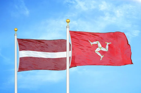 Latvia Isle Mann Two Flags Flagpoles Blue Cloudy Sky Background — Stock Photo, Image