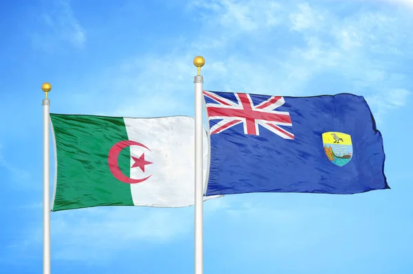 Algeria and Saint Helena two flags on flagpoles and blue cloudy sky background