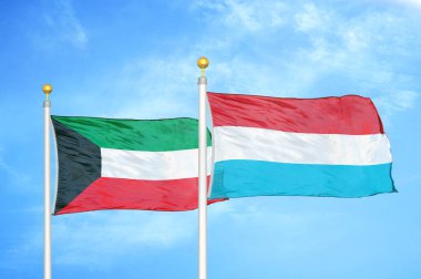 Kuveyt ve Lüksemburg bayrak direkleri ve mavi bulutlu arka planda iki bayrak