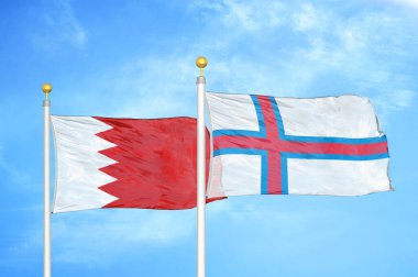 Bahreyn ve Faroe Adaları bayrak direkleri ve mavi bulutlu arka planda iki bayrak