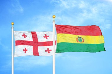 Gürcistan ve Bolivya bayrak direkleri ve mavi bulutlu arka planda iki bayrak