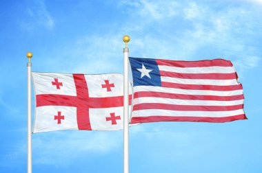 Gürcistan ve Liberya bayrak direkleri üzerinde iki bayrak ve mavi bulutlu arka plan