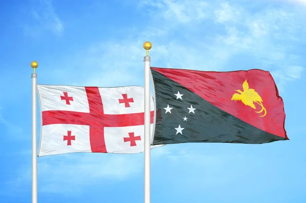 Gruzie Papua Nová Guinea Dvě Vlajky Vlajkových Stožárech Modrá Oblačná — Stock fotografie