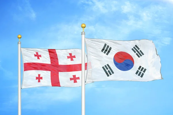 Georgia Corea Del Sud Due Bandiere Pennoni Cielo Azzurro Nuvoloso — Foto Stock