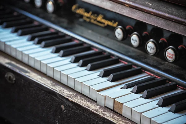 Old organ one row piano keys in the church