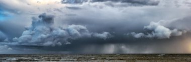 Picture of storm with dramatic clouds at the sea. clipart