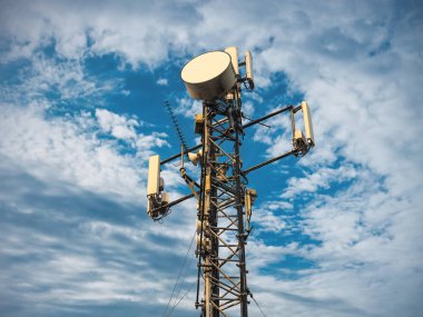 3G, 4G and 5G cellular. Base Station or Base Transceiver Station. Telecommunication tower. Wireless Communication Antenna Transmitter. Telecommunication tower with antennas against blue sky. clipart