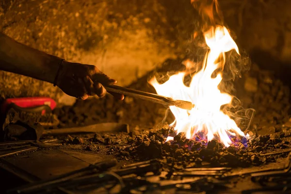 Treatment of molten metal close-up. Handmade blacksmith.