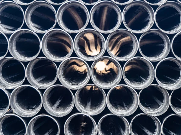 Black plastic pipes of various diameters in a row — Stock Photo, Image