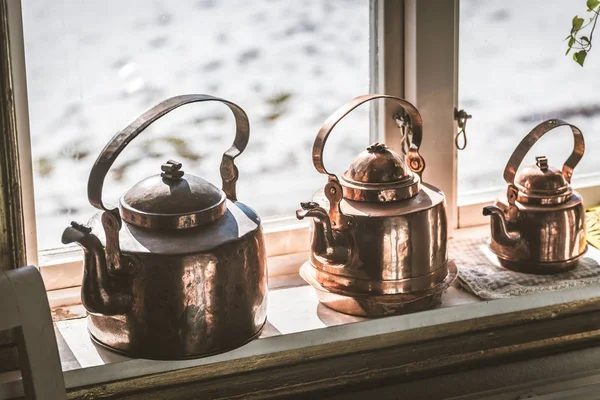 Vintage old style metal kettle on the window sill — Stock Photo, Image
