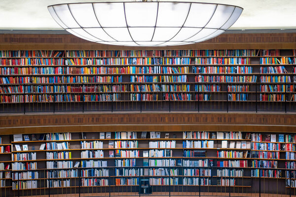 Colorful wall of books on the shelfs at the rotunda in Stockholm Stadsbibliotek or Public Library.