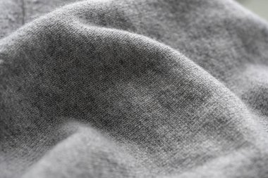 Seçici odak ve arka plan ışığına sahip yumuşak gri kumaş görüntüsü