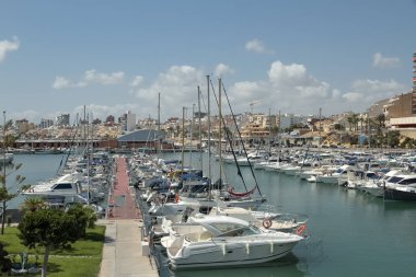 horizontal view of some boats inside sports port in the coastal municipality of El campello in the province of alicante, spain clipart
