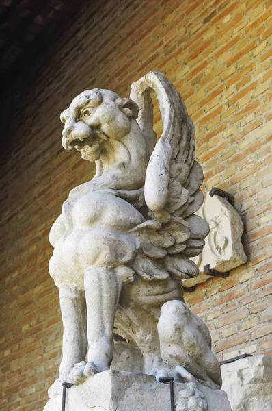 arka plan olarak tuğla bir duvar ile taşa oyulmuş gargoyle