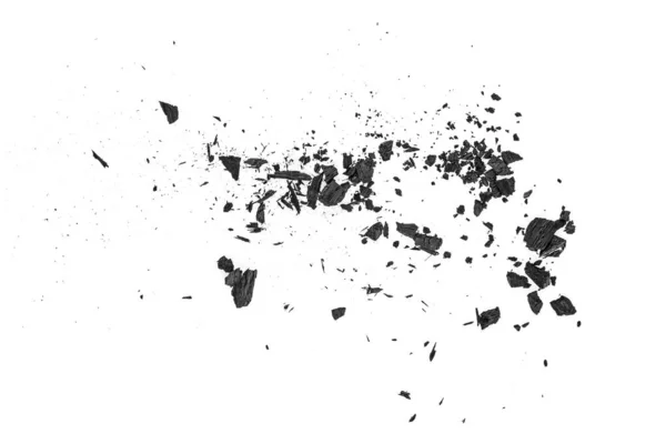 Pequenos pedaços de pó de carvão no fundo branco, vista superior . — Fotografia de Stock