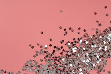 Pembe arka planda gümüş parıltılı yıldızlar. Bayramlık pastel. 