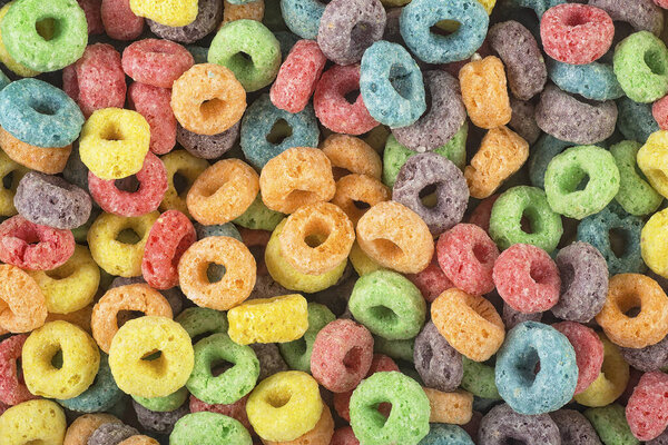 Background of round colorful cereal. Colorful breakfast food. Colorful cereal loop rings.