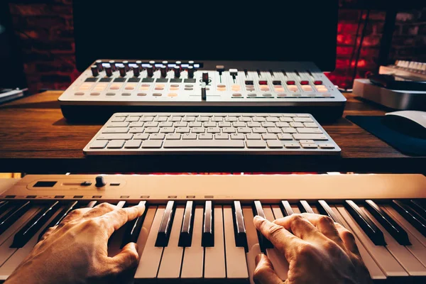musician hands playing piano for recording a song on computer. music production concept