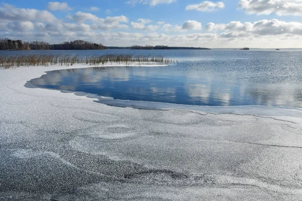 Thin ice on the lake Uvildy in late autumn in clear weather, Chelyabinsk region. Russia