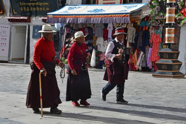 Tibet, Lhasa, China, June, 02, 2018.   People walking along the ancient Barkhor street on a summer day in cloudy weather clipart