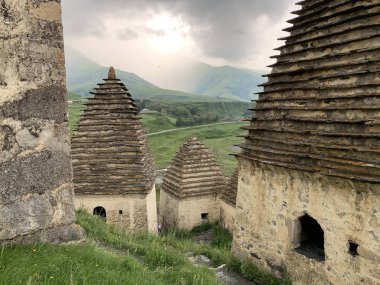 Russia.North Ossetia. Dargavs. City of the dead in cloudy summer day clipart