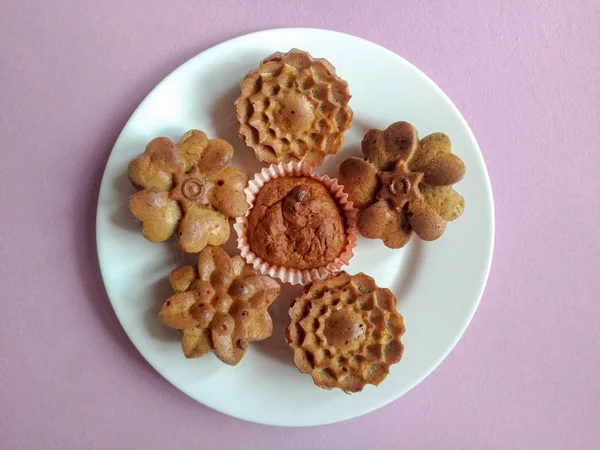 sugar-free muffins on a white plate on a purple background