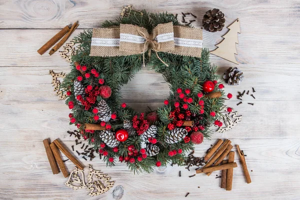 Wreath Christmas winter frame. White wooden background