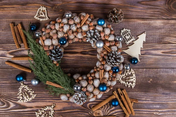 Christmas winter frame on dark wooden background. Christmas wreath. Blue elements