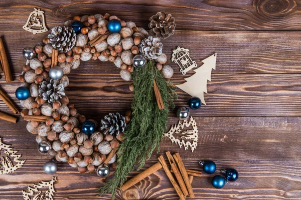 Christmas winter frame on dark wooden background. Christmas wreath. Blue elements