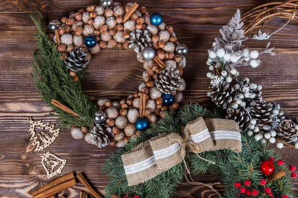 Christmas winter frame on dark wooden background. Christmas wreath. Blue elements. red elements