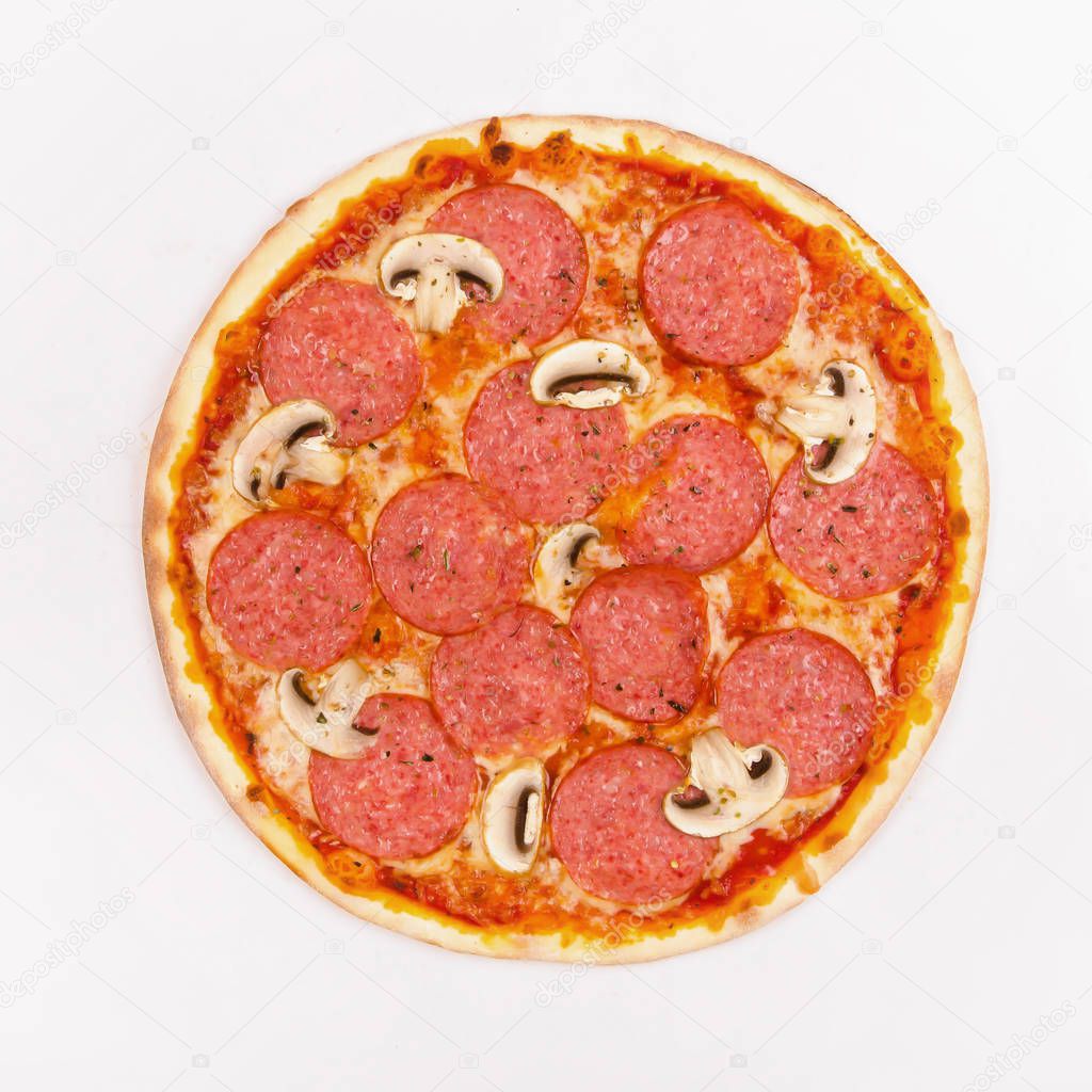 Pizza with salami and mushrooms on a white