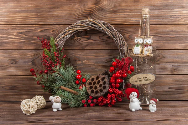 Wreath. Christmas winter frame on dark wooden background. Red elements The inscription in Russian \