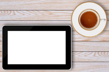 tablet bilgisayar ve kahve fincanı