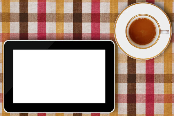 tablet computer and coffee cup