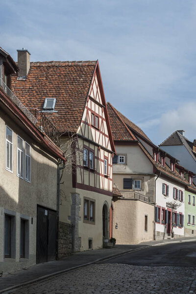 ROTHENBURG OB DER TAUBER, GERMANY - MARCH 05, 2018: Historic colorful half-timbered houses in the medieval town Rothenburg ob der Tauber, one of the most beautiful villages in Europe, Germany,