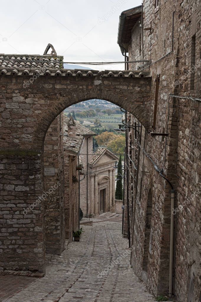 Spectacular traditional italian medieval alley in the historic center of beautiful little town of Spello (Perugia), in Umbria region - central Italy