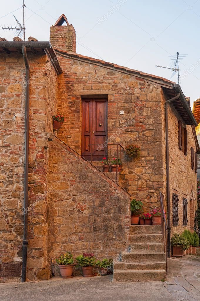 Montichiello - Italy, October 29, 2016: Quiet street in Montichiello, Tuscany with typical shuttered windows and paved streets. Italy