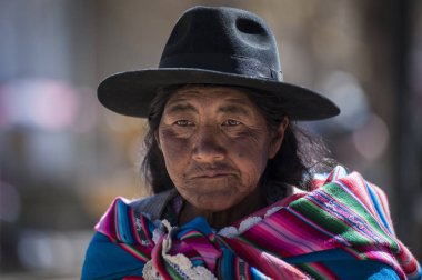 Unidentified indigenous native Quechua woman with traditional tribal clothing and hat, at the Tarabuco Sunday Market, Bolivia clipart