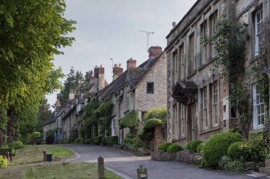 Quaint Cotswold romantic stone cottages on The Hill,  in the lovely Burford village, Cotswolds, Oxfordshire, England  clipart