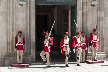 LA PAZ, BOLIVIA - AUGUST 19, 2017 : Changing of the guards outside the Palacio Quemado, the Bolivian Palace of  Government, in Plaza Murillo - Bolivia clipart