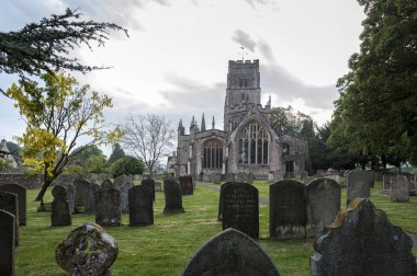 St Peter and St Pauls Church and its graveyard with tombs in Northleach town, Gloucestershire, Cotswolds, England - United Kingdom clipart
