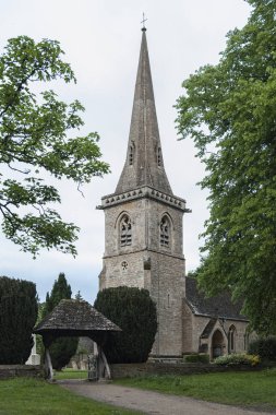 LOWER SLAUGHTER, COTSWOLDS, GLOUCESTERSHIRE, ENGLAND - MAY, 27 2018: Mary's Church with graveyard in the village of Lower Slaughter, Cotswolds, Gloucestershire, England, UK clipart