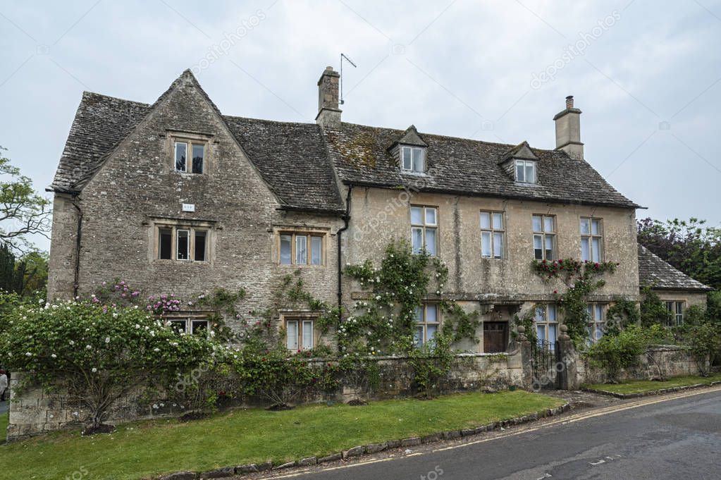BIBURY, COTSWOLDS, UK - MAY 28, 2018: Traditional cotswold stone cottages built of distinctive yellow limestone in the lovely village of Bibury, Gloucestershire, England   