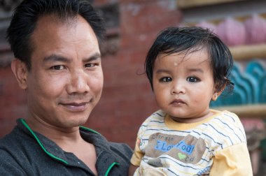 KATHMANDU, NEPAL - 14 AĞUSTOS 2018: Kimliği belirsiz nepalli adam ve küçük çocuğu Nepal Katmandu caddesinde   